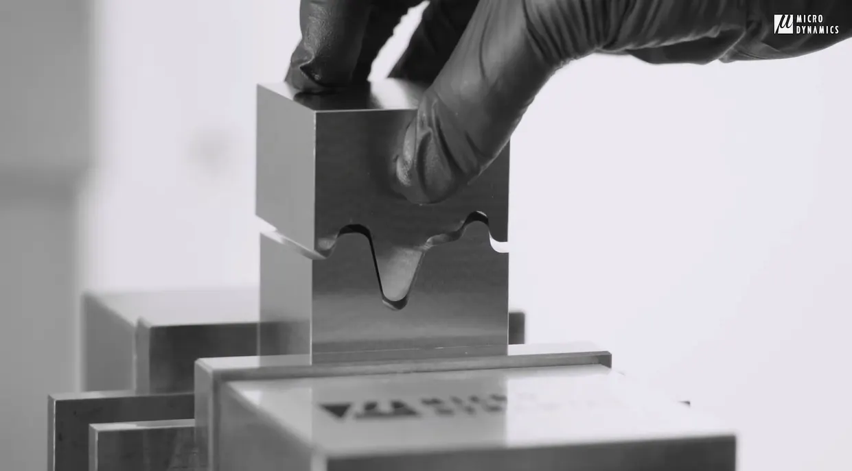 A machinist matching two parts of a mating mold in an attempt to have a seamless fit