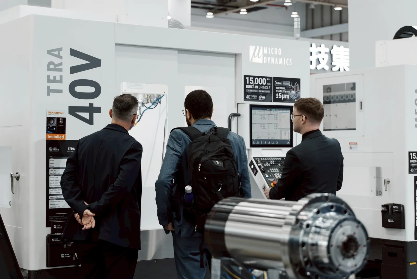 TMTS 2026 Microdynamics Booth Visitors Viewing The Live Aluminum Fast Cutting Demonstration